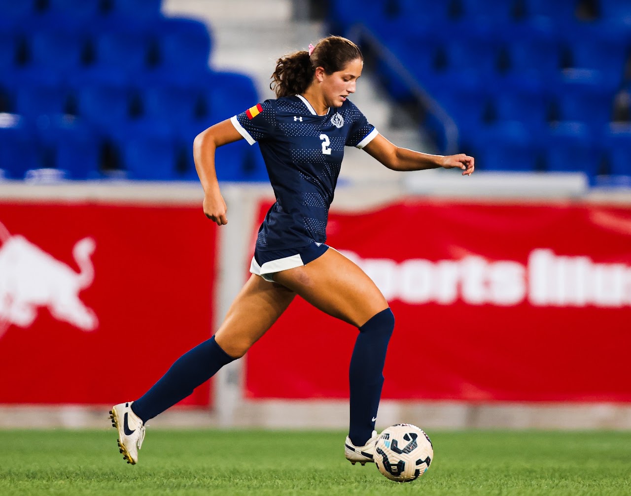 Maya Rebimbas playing soccer in her navy number 2 uniform